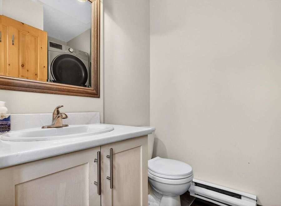 This charming bathroom features a stylish vanity with a sleek countertop and modern fixtures.