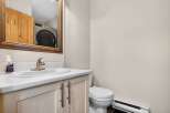 This charming bathroom features a stylish vanity with a sleek countertop and modern fixtures.