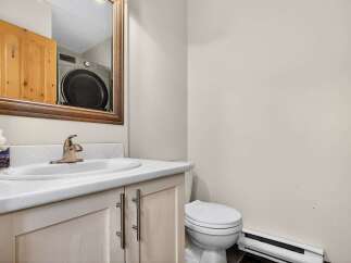 This charming bathroom features a stylish vanity with a sleek countertop and modern fixtures.