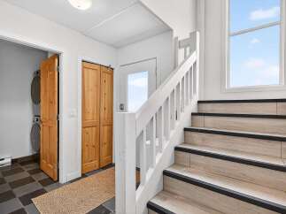 This stunning property features a beautifully designed staircase leading to the upper levels.
