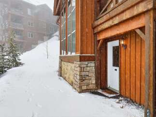 This stunning property boasts a beautiful exterior with wooden siding and stone accents, creating a warm and inviting atmosphere.