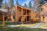 This charming two-story property offers a warm and inviting exterior with its wooden siding and inviting porch.