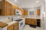 This charming kitchen boasts ample cabinet space and a bright, inviting atmosphere.