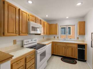 This charming kitchen boasts ample cabinet space and a bright, inviting atmosphere.