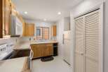 Step into this inviting kitchen, featuring warm wooden cabinetry and ample counter space.
