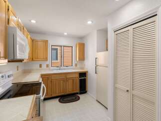 Step into this inviting kitchen, featuring warm wooden cabinetry and ample counter space.