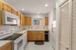 Step into this inviting kitchen, featuring classic wooden cabinetry and ample counter space, perfect for meal preparation.