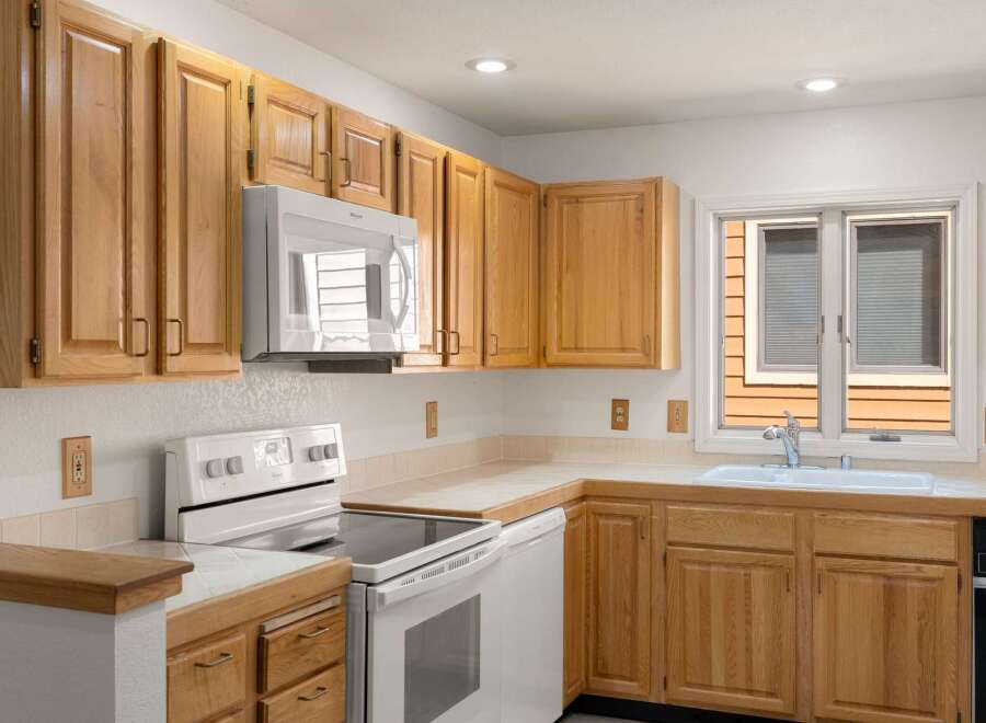This charming kitchen boasts beautiful wooden cabinetry, offering ample storage space for all your culinary essentials.
