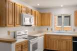 This charming kitchen boasts beautiful wooden cabinetry, offering ample storage space for all your culinary essentials.