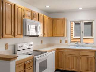 This charming kitchen boasts beautiful wooden cabinetry, offering ample storage space for all your culinary essentials.