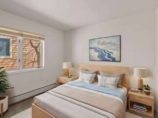 This cozy bedroom offers a serene retreat with its natural wood accents and calming color palette.