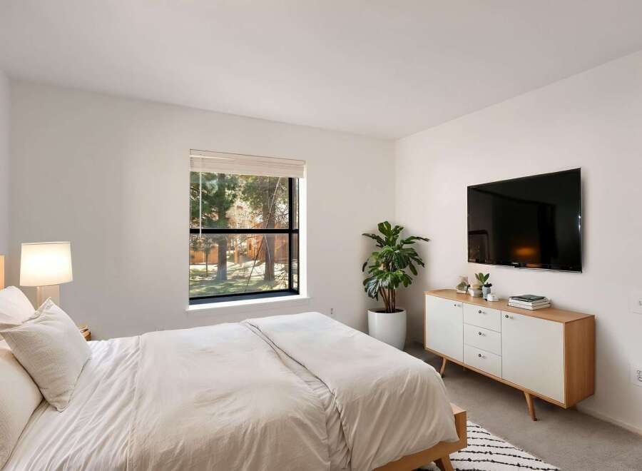 This modern bedroom offers a serene retreat with its minimalist design and natural light.