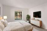 This modern bedroom offers a serene retreat with its minimalist design and natural light.
