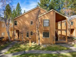 Discover a charming two-story home with a warm, inviting exterior.