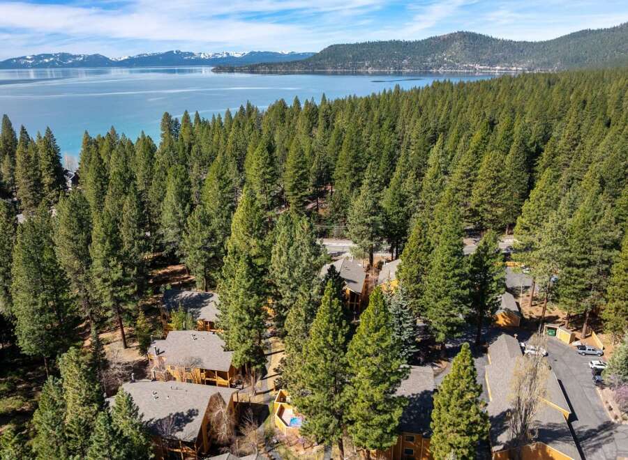 Nestled amidst a lush forest, this property offers a serene escape with stunning lake views.