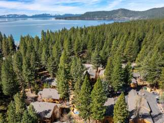 Nestled amidst a lush forest, this property offers a serene escape with stunning lake views.
