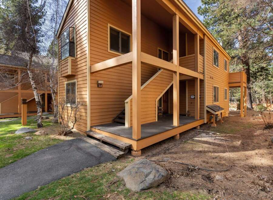 Discover the charm of this inviting property, featuring a warm, wood-toned exterior and a welcoming porch.
