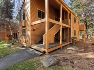 Discover the charm of this inviting property, featuring a warm, wood-toned exterior and a welcoming porch.