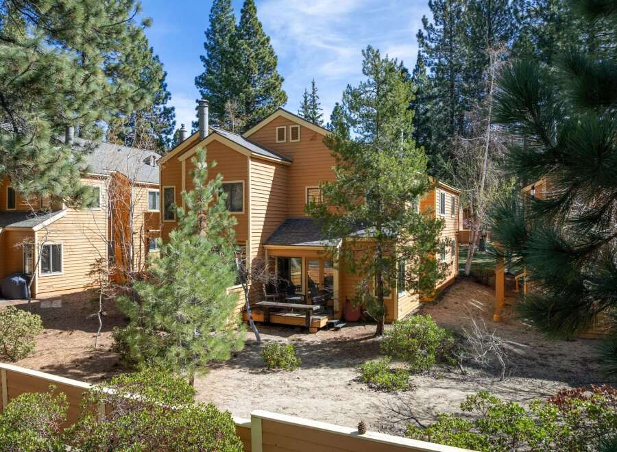 Nestled amidst towering pines, this charming property offers a serene retreat.