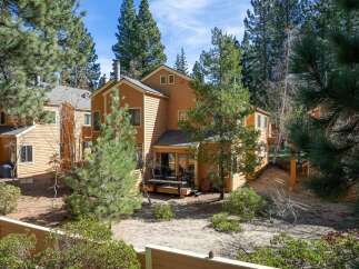 Nestled amidst towering pines, this charming property offers a serene retreat.