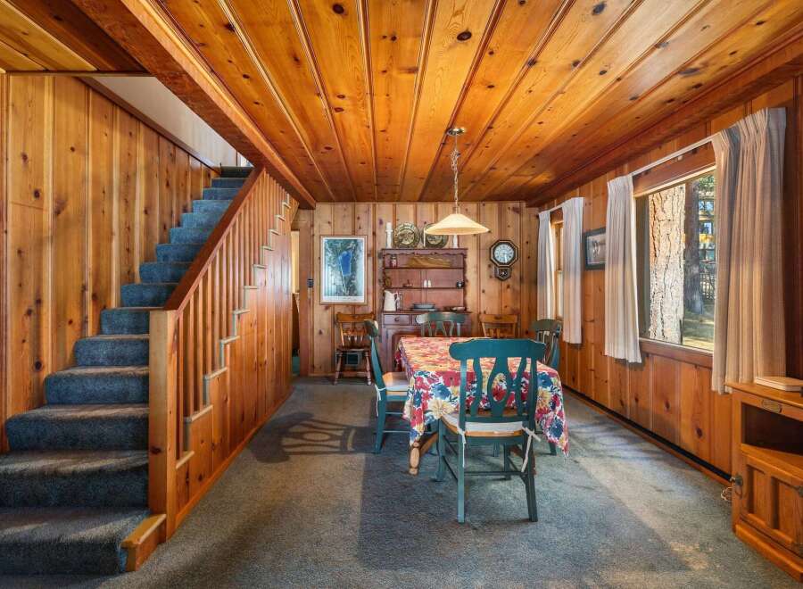 Step into this charming cabin with its warm wood paneling and inviting atmosphere.