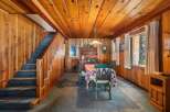 Step into this charming cabin with its warm wood paneling and inviting atmosphere.