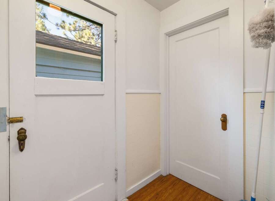 Step into this inviting space, featuring a bright entryway with two doors.