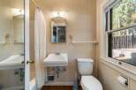 Step into this charming bathroom, featuring classic tile work and a bright, airy feel.