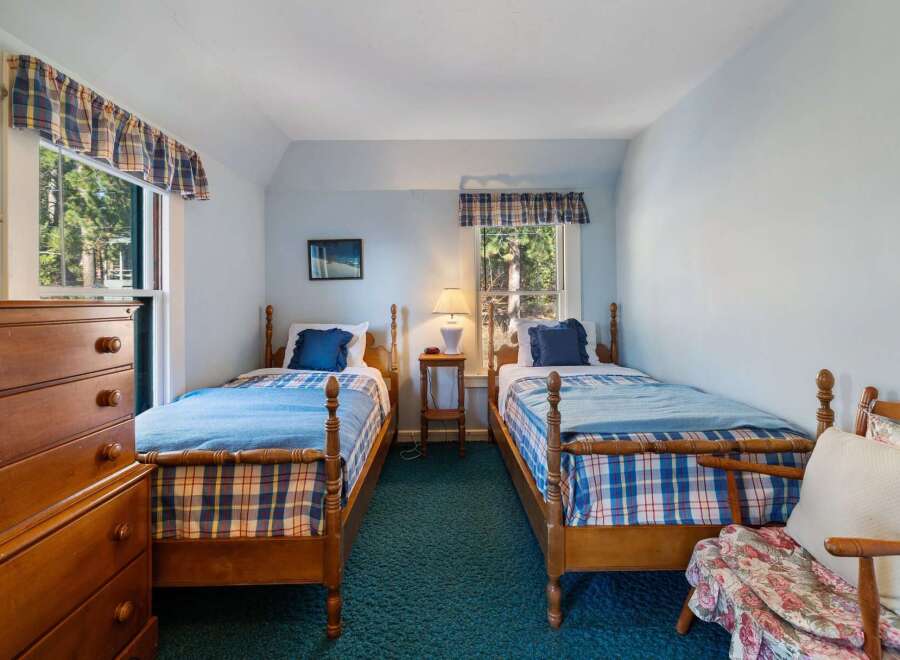 This charming bedroom features two twin beds with cozy bedding, perfect for guests or family.