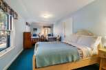 This charming bedroom features three beds, perfect for accommodating guests or family.
