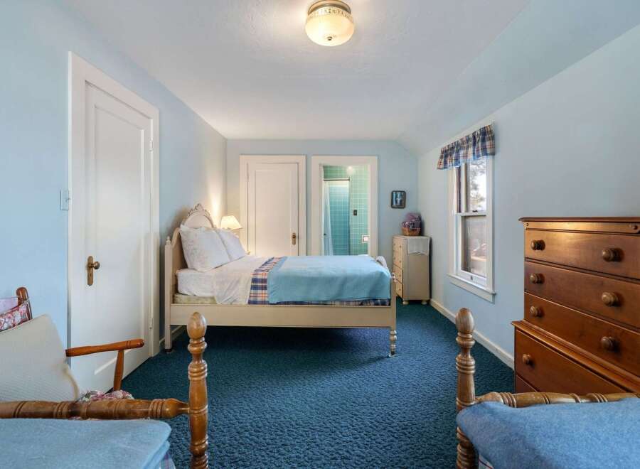 Step into this charming bedroom, featuring a cozy bed and ample natural light.