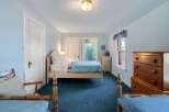 Step into this charming bedroom, featuring a cozy bed and ample natural light.