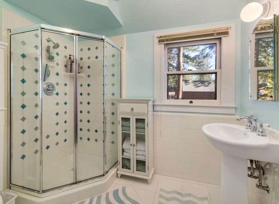 Step into a beautifully designed bathroom featuring a modern glass shower enclosure.