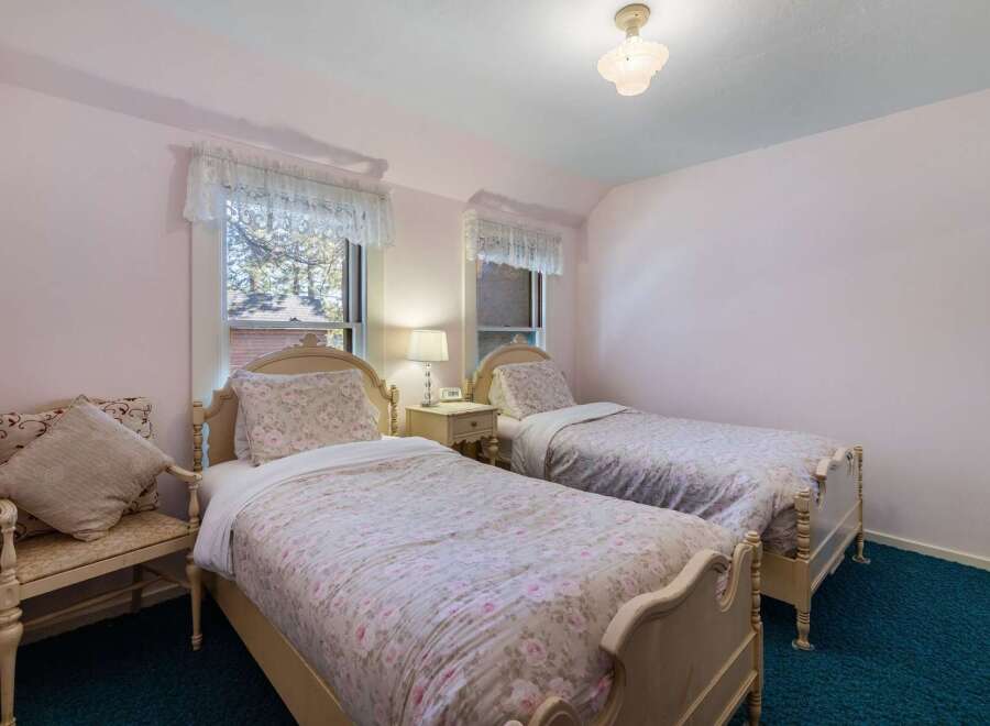 Charming bedroom featuring two twin beds, perfect for guests or a shared space.