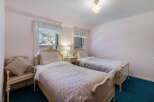 Charming bedroom featuring two twin beds, perfect for guests or a shared space.