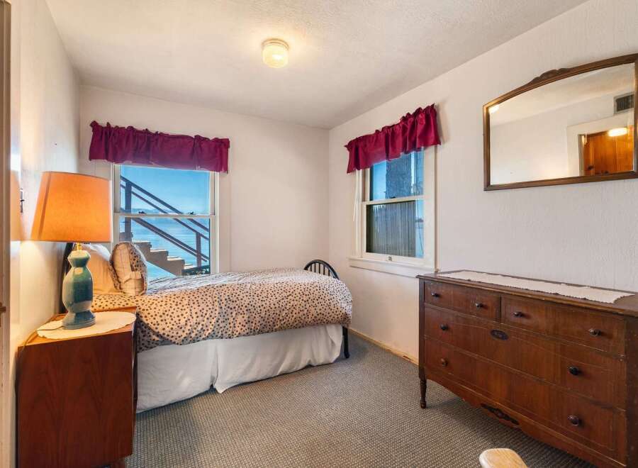 This charming bedroom offers a cozy retreat with stunning views.