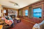Cozy up in this charming living room with a stunning lake view.