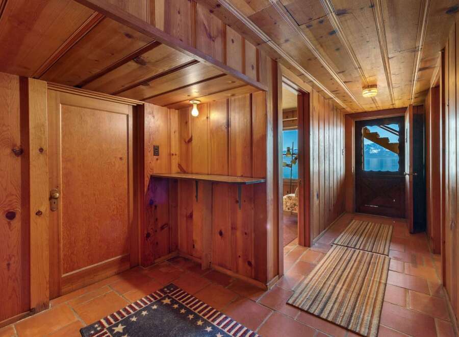 Step into a world of rustic charm with this stunning property, featuring exquisite wood paneling throughout.