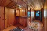 Step into a world of rustic charm with this stunning property, featuring exquisite wood paneling throughout.
