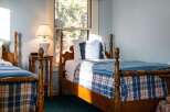 This charming bedroom features two twin beds, perfect for guests or family.