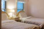 Charming bedroom featuring two twin beds with floral bedding, perfect for guests or a cozy retreat.