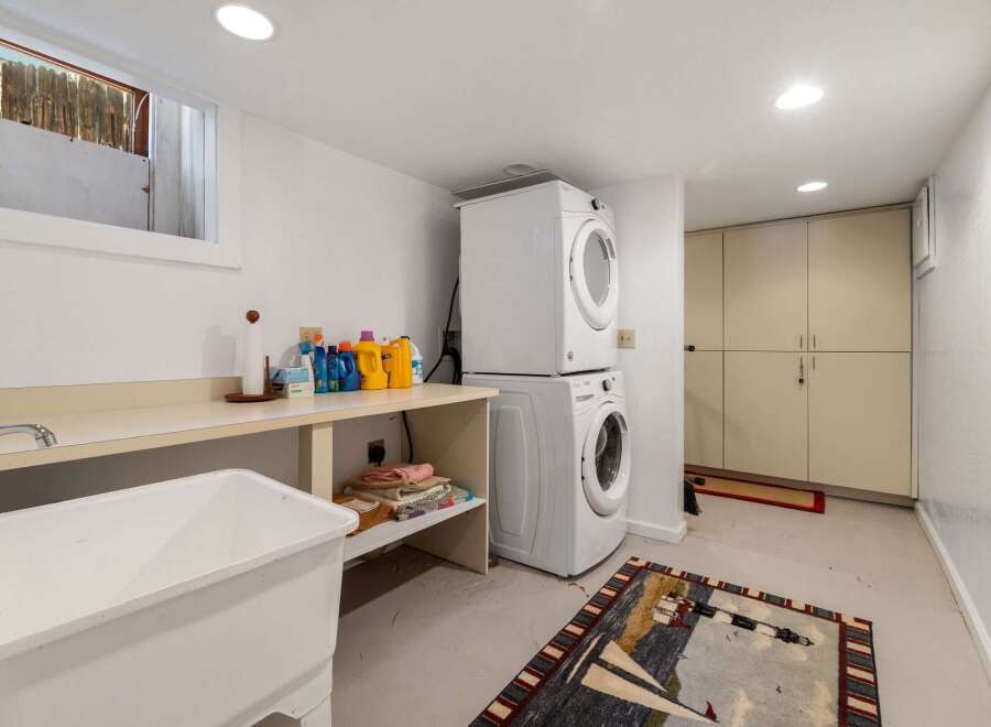 This laundry room offers a functional and organized space for all your washing needs.