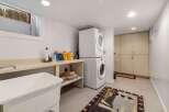 This laundry room offers a functional and organized space for all your washing needs.