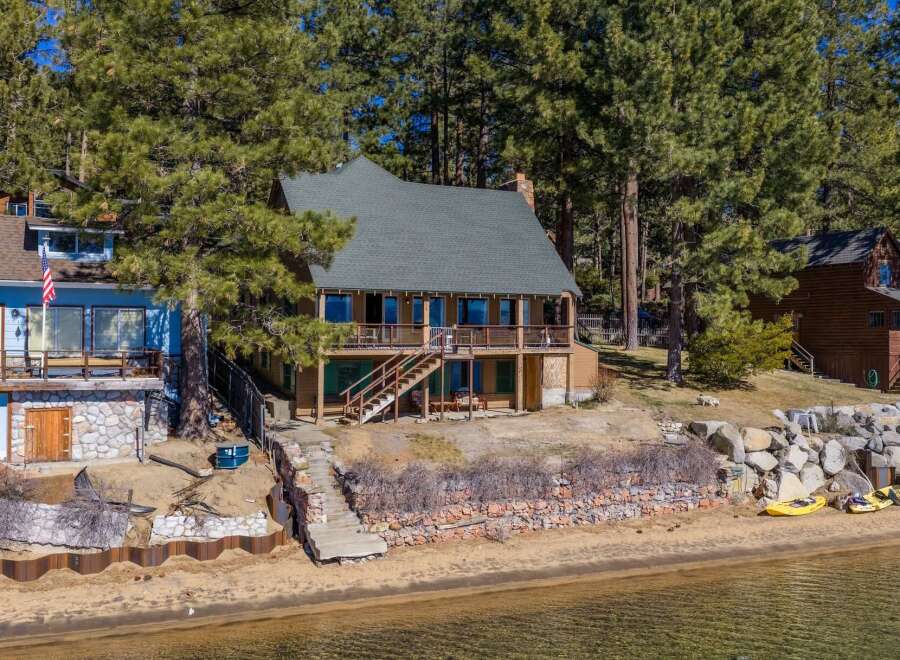 Discover your dream lakeside retreat! This stunning property boasts a charming two-story house with a beautiful deck, perfect for enjoying breathtaking views.