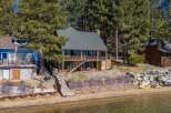 Discover your dream lakeside retreat! This stunning property boasts a charming two-story house with a beautiful deck, perfect for enjoying breathtaking views.