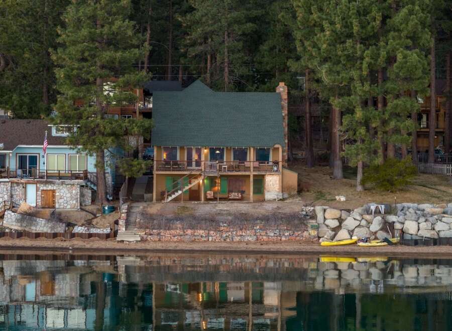 Discover your dream lakeside retreat! This stunning property boasts a charming two-story home with a cozy fireplace and a spacious deck overlooking the serene lake.