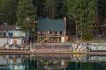 Discover your dream lakeside retreat! This stunning property boasts a charming two-story home with a cozy fireplace and a spacious deck overlooking the serene lake.