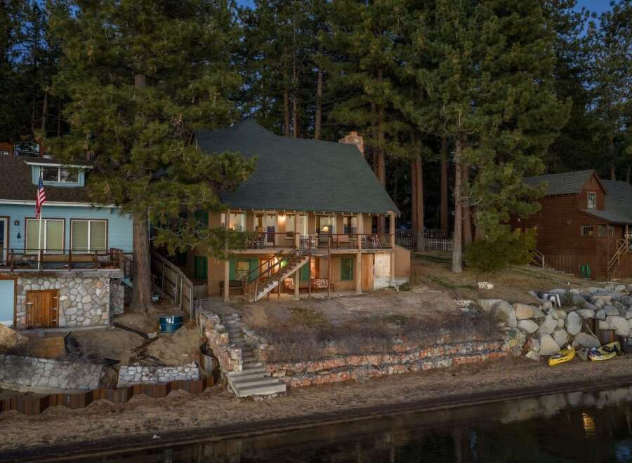 Nestled amidst towering trees, this charming waterfront property offers a serene escape.