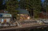 Nestled amidst towering trees, this charming waterfront property offers a serene escape.