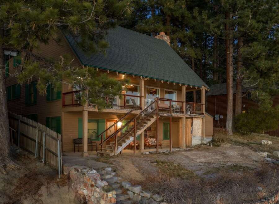 This charming cabin offers a serene retreat with its inviting exterior and picturesque setting.